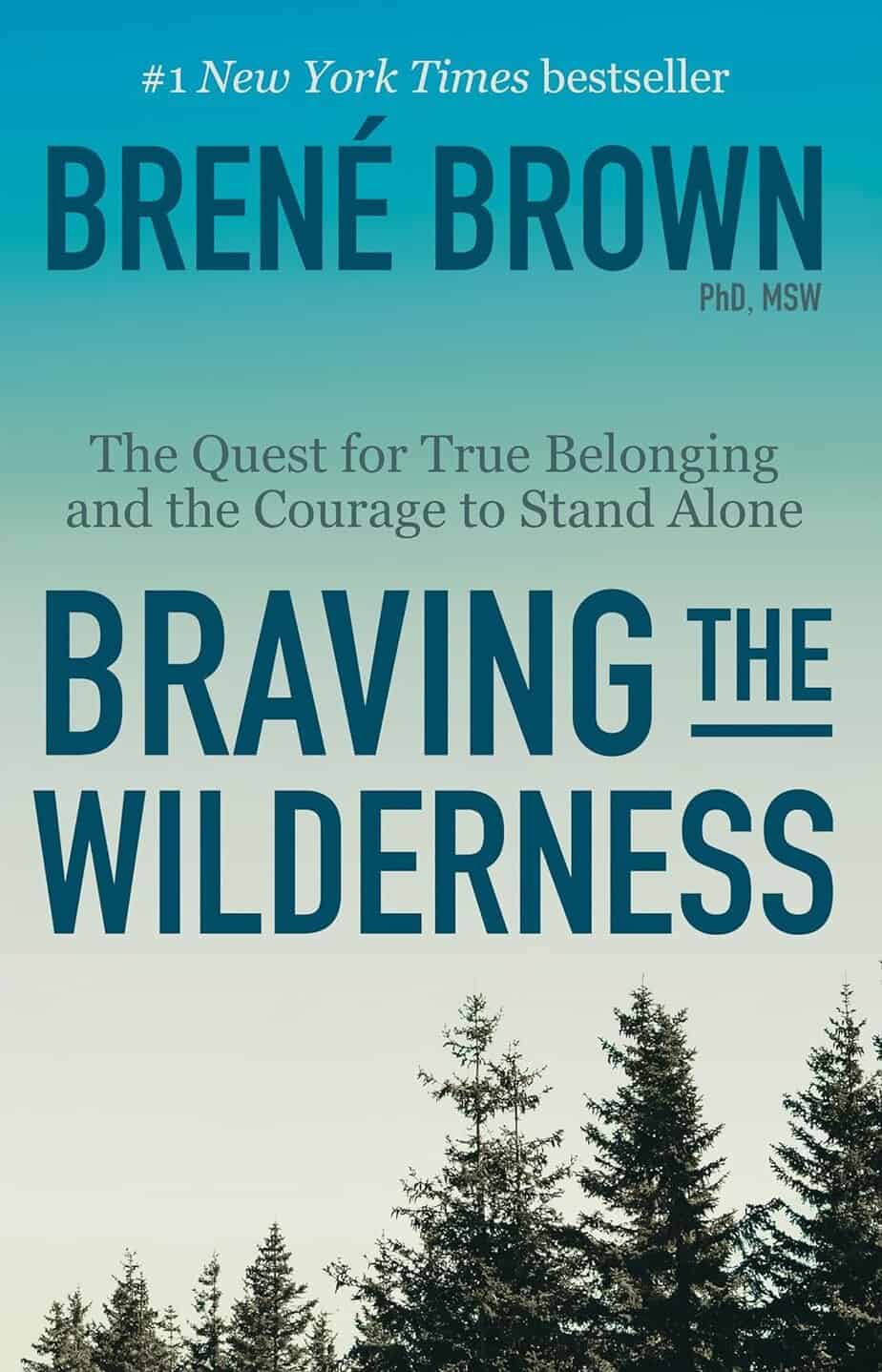 Book cover for "Braving the Wilderness" by Bren&eacute; Brown, featuring a gradient blue sky, pine treetops, and bold title text. Subtitle: "The Quest for True Belonging and the Courage to Stand Alone." Explores human connection in a lonely world.