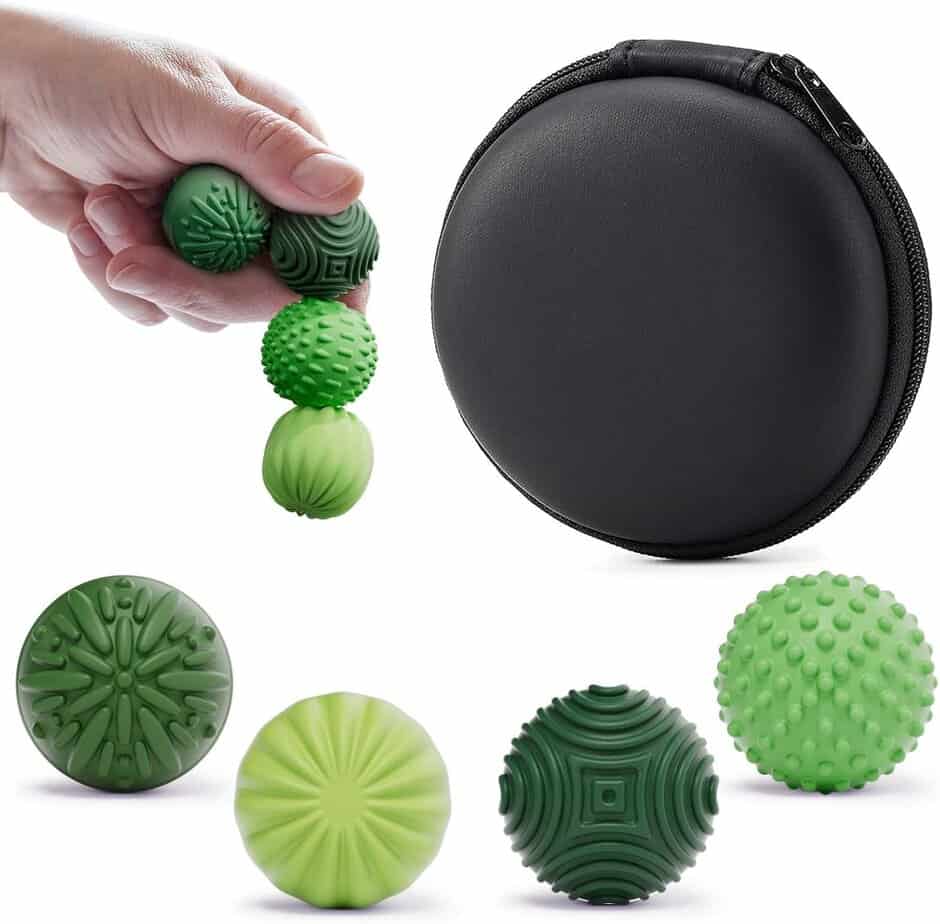 A hand holds three textured green massage balls next to a round black zippered case. Four different green massage balls with various textures are displayed below the case on a white background.